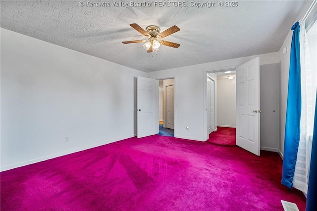 unfurnished bedroom featuring carpet floors, baseboards, ceiling fan, and a textured ceiling