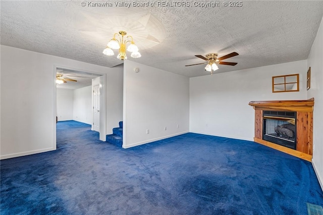 unfurnished living room with ceiling fan, carpet flooring, a fireplace, a textured ceiling, and baseboards