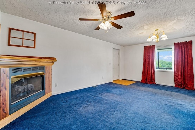 unfurnished living room featuring carpet flooring, a chandelier, a textured ceiling, a glass covered fireplace, and ceiling fan