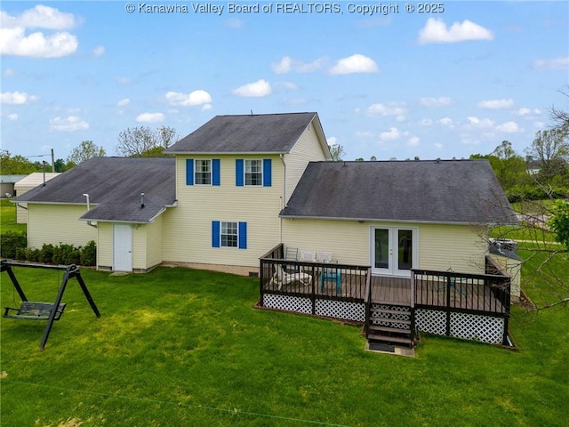back of house featuring a wooden deck, a lawn, french doors, and a shingled roof