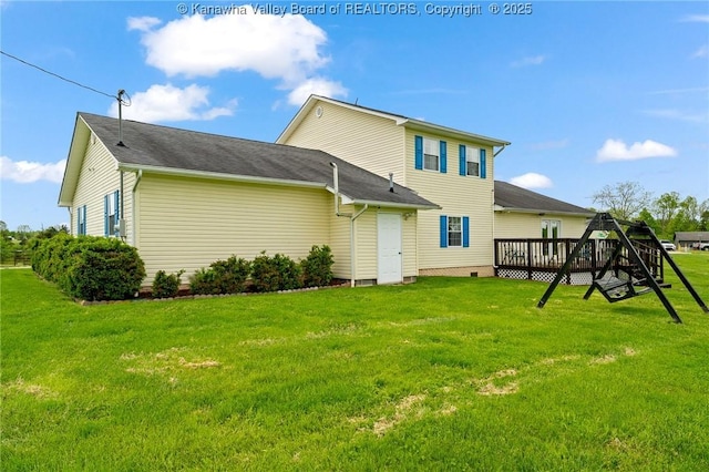 back of house featuring a deck and a yard
