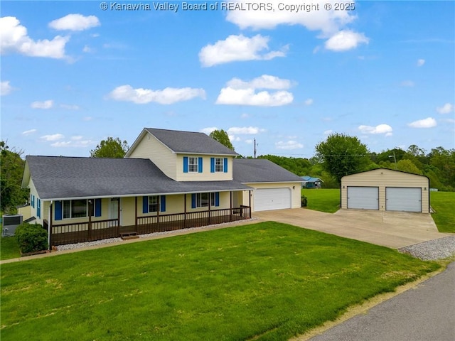 view of front of house featuring a porch, a front yard, a detached garage, and an outdoor structure