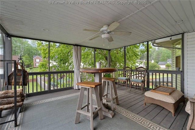 sunroom featuring ceiling fan