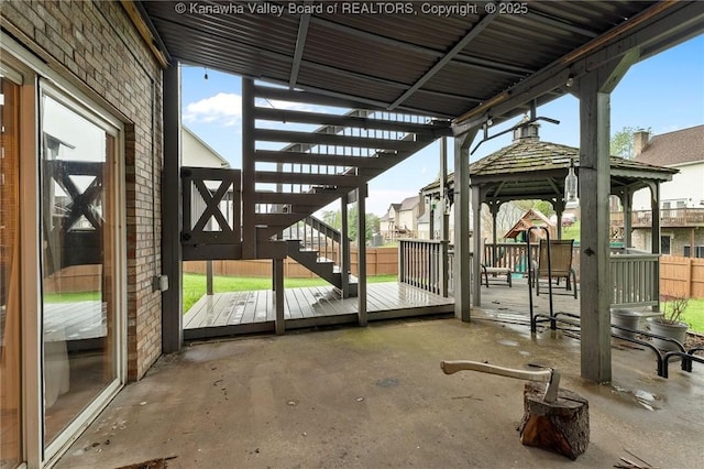 view of patio / terrace with a gazebo, stairway, fence, and a wooden deck