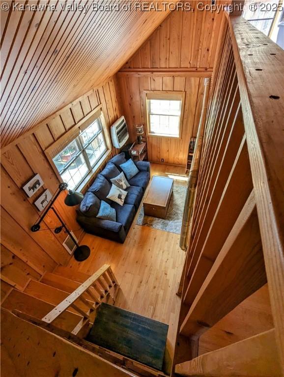 6531 Lockbridge Rd, Wv, WV 25976 - living area with lofted ceiling, wooden walls, plenty of natural light, and hardwood / wood-style flooring