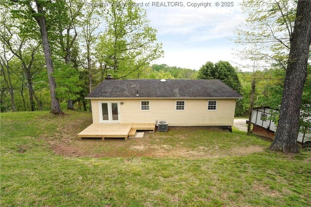 back of property featuring a wooden deck, a yard, and central AC unit