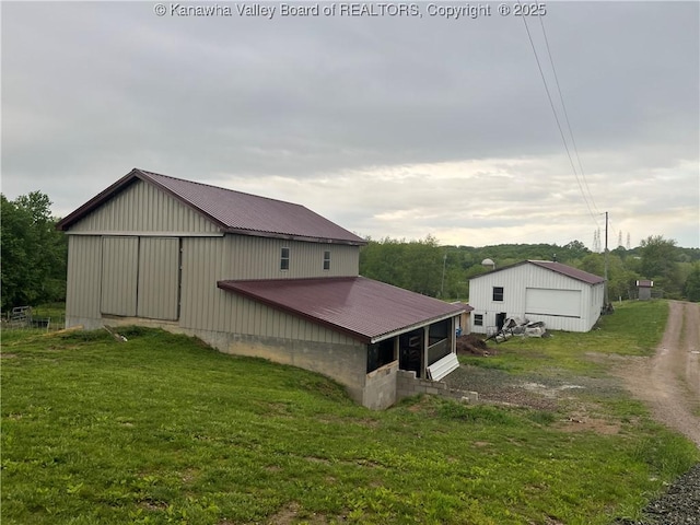 5860 Union Campground Rd, Letart, WV 25253 - view of property exterior with an outbuilding, metal roof, and a lawn
