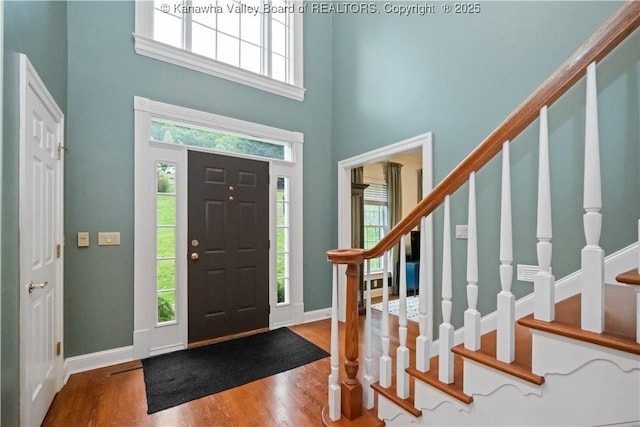 12 W Coventry Rd, South Charleston, WV 25309 - foyer featuring a high ceiling, wood finished floors, healthy amount of natural light, and stairway