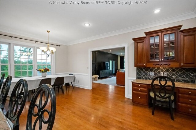 12 W Coventry Rd, South Charleston, WV 25309 - dining area featuring ornamental molding, a wainscoted wall, light wood-style flooring, a chandelier, and recessed lighting