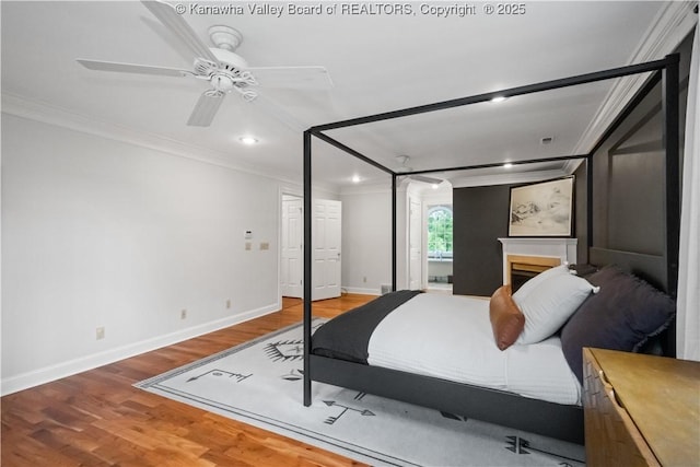 12 W Coventry Rd, South Charleston, WV 25309 - bedroom featuring ornamental molding, recessed lighting, baseboards, wood finished floors, and a fireplace