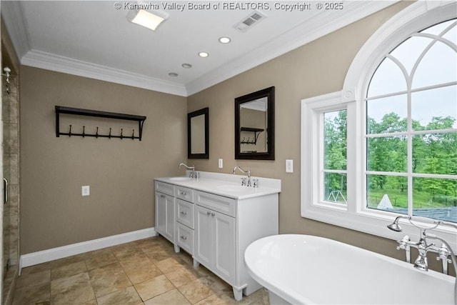 12 W Coventry Rd, South Charleston, WV 25309 - bathroom with ornamental molding, a soaking tub, baseboards, double vanity, and recessed lighting