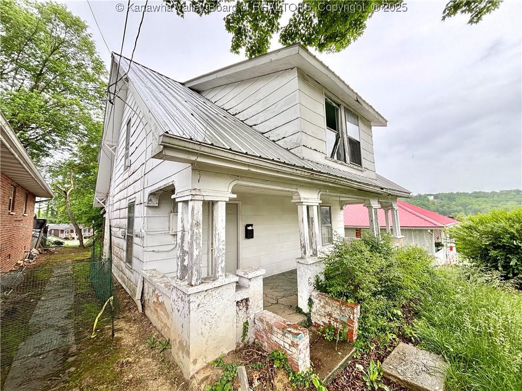 324 High School Ave, Hurricane, WV 25526 - view of side of property featuring metal roof