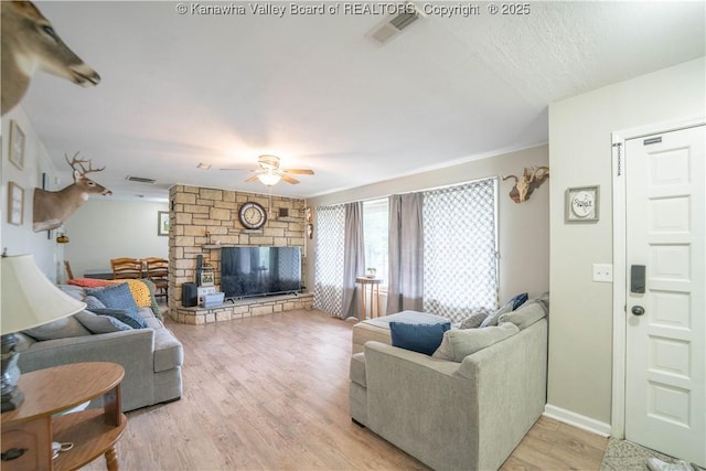 2611 Larwood Dr, Charleston, WV 25302 - living room featuring a fireplace, a ceiling fan, light wood-style floors, and baseboards