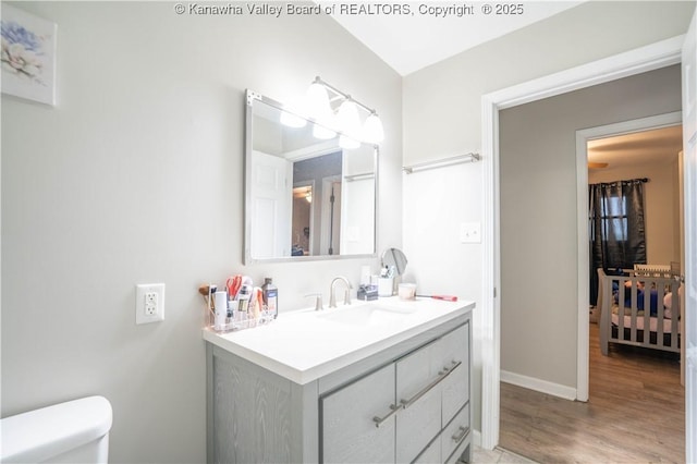 2611 Larwood Dr, Charleston, WV 25302 - half bath with wood finished floors, toilet, vanity, and baseboards