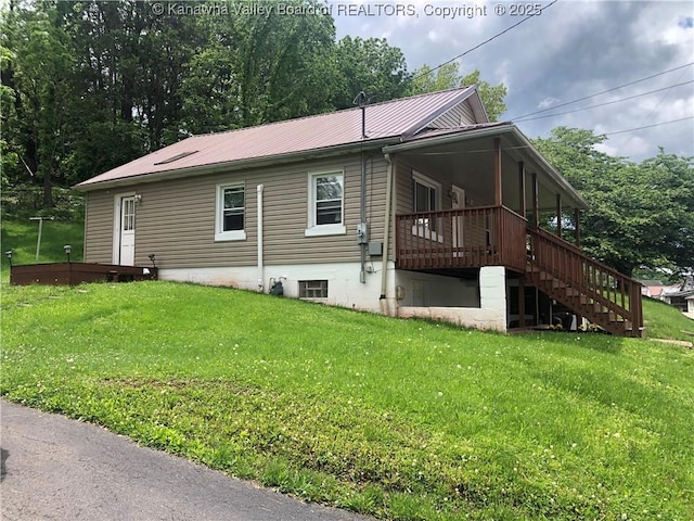 329 3rd Ave, Ripley, WV 25271 - view of side of property with stairs, a lawn, metal roof, and a deck