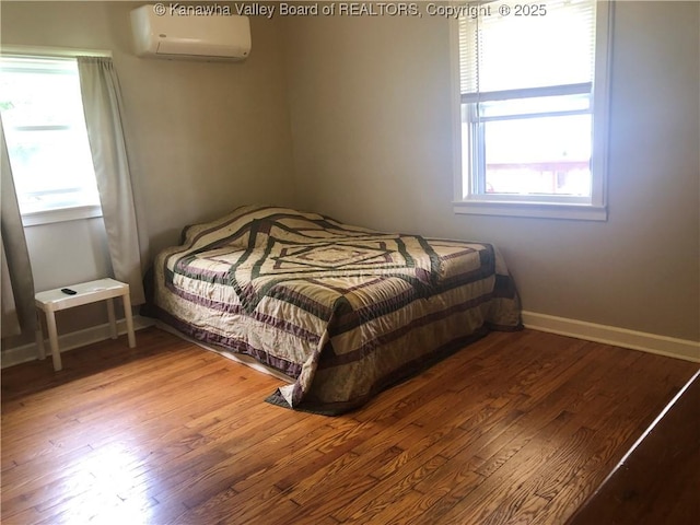 329 3rd Ave, Ripley, WV 25271 - bedroom with a wall mounted AC, multiple windows, wood finished floors, and baseboards