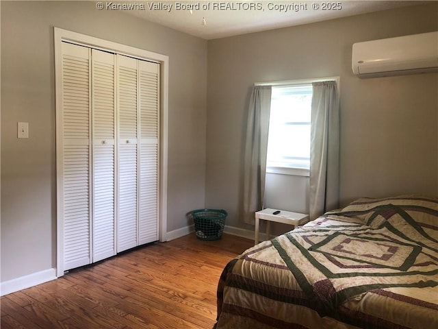 329 3rd Ave, Ripley, WV 25271 - bedroom featuring a wall mounted air conditioner, wood finished floors, a closet, and baseboards