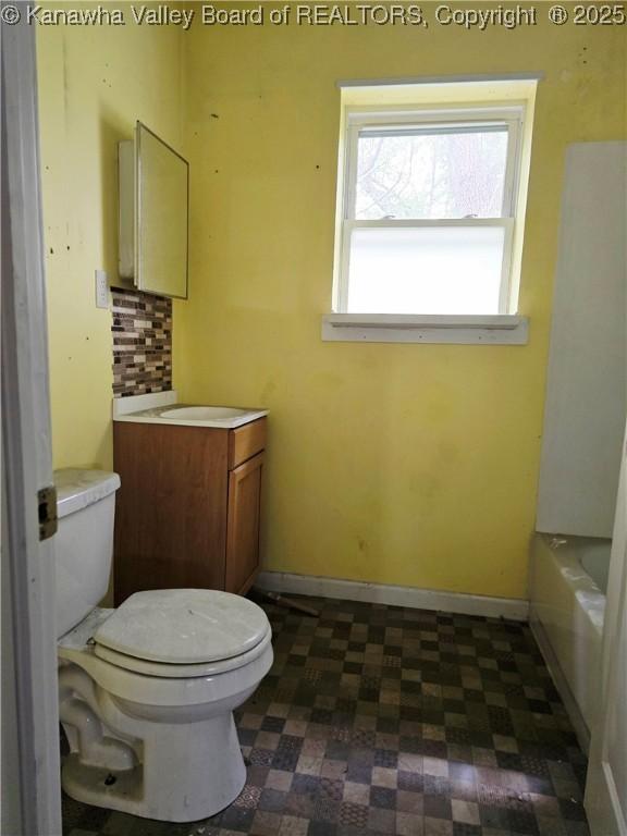 1619 Livingston Ave, Charleston, WV 25387 - bathroom with tile patterned floors, toilet, vanity, a bathtub, and baseboards