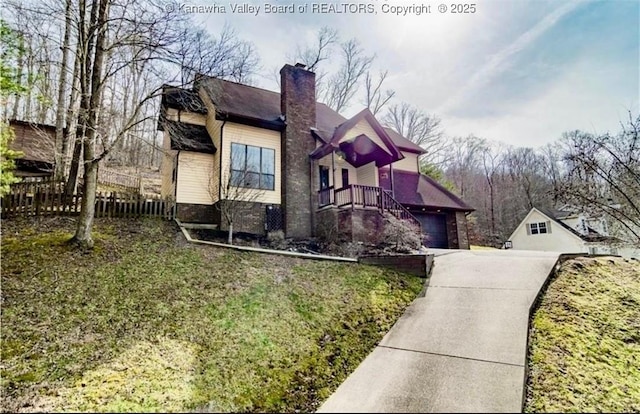 5427 Hillbrook Dr, Charleston, WV 25313 - view of property exterior with driveway, a chimney, and a garage
