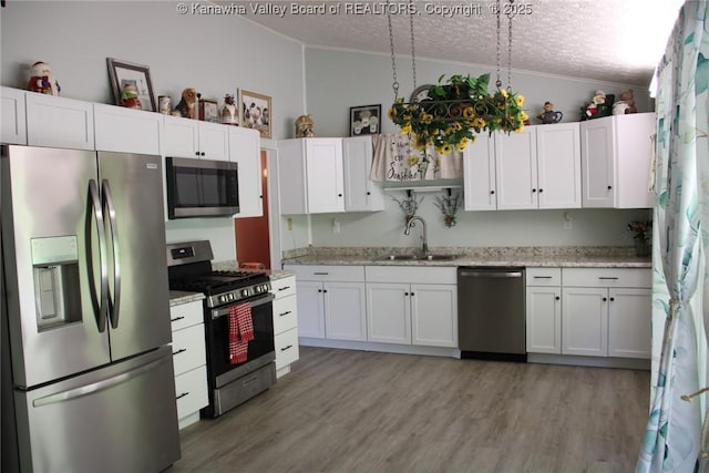 1741 Huber Rd, Charleston, WV 25314 - kitchen featuring appliances with stainless steel finishes, a sink, crown molding, white cabinets, and a textured ceiling