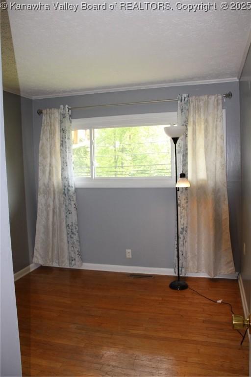 1741 Huber Rd, Charleston, WV 25314 - spare room with crown molding, baseboards, and wood finished floors