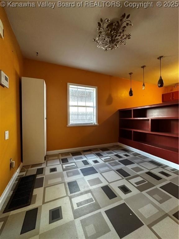 1603 Frame St, Charleston, WV 25387 - unfurnished living room with baseboards and tile patterned floors