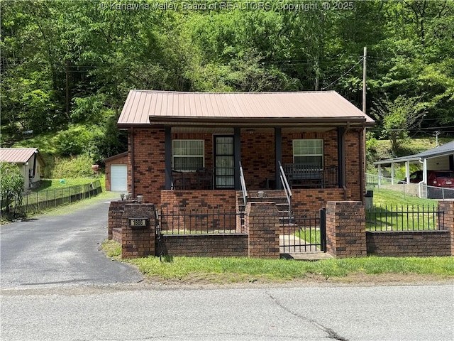 1886 Whitman Creek Rd, Whitman, WV 25652 - view of front facade with a porch, a fenced front yard, brick siding, and asphalt driveway