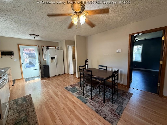 1886 Whitman Creek Rd, Whitman, WV 25652 - dining space featuring ceiling fan, light wood-style flooring, a textured ceiling, and baseboards