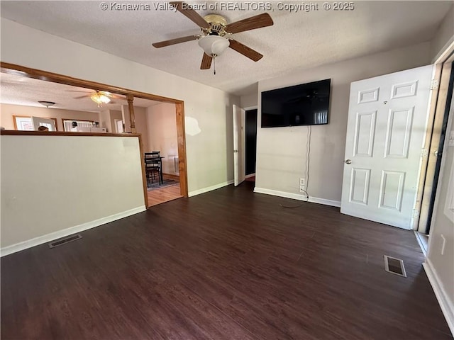 1886 Whitman Creek Rd, Whitman, WV 25652 - unfurnished living room with ceiling fan, a textured ceiling, wood finished floors, and baseboards