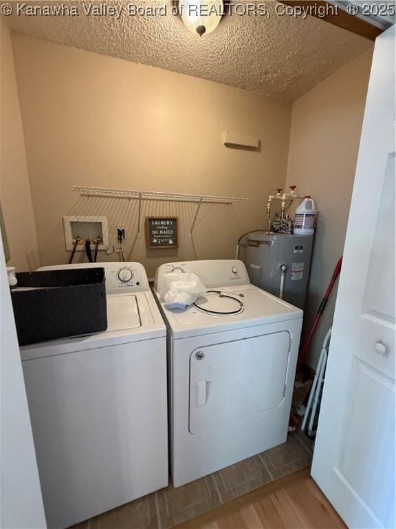 1886 Whitman Creek Rd, Whitman, WV 25652 - clothes washing area with electric water heater, separate washer and dryer, wood finished floors, and a textured ceiling