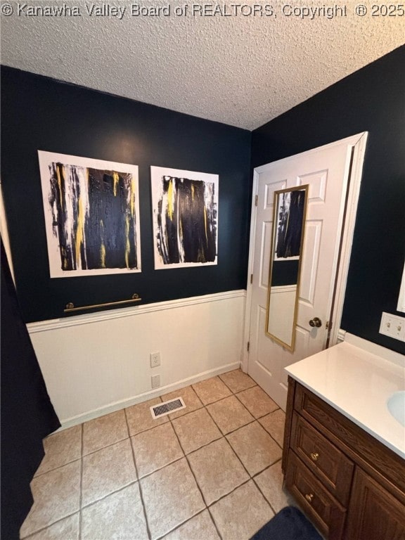 1886 Whitman Creek Rd, Whitman, WV 25652 - bathroom with a textured ceiling, tile patterned flooring, and vanity