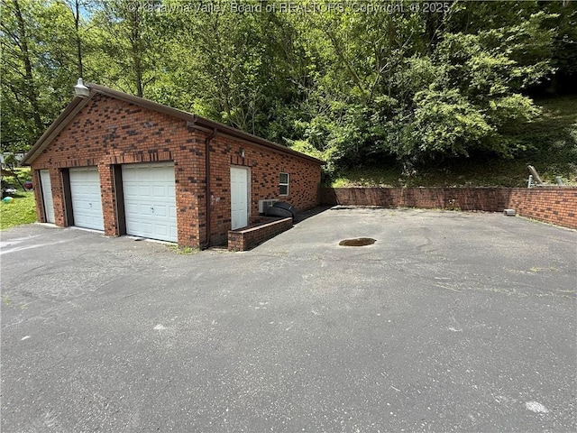 1886 Whitman Creek Rd, Whitman, WV 25652 - view of home's exterior with a garage, an outdoor structure, and brick siding