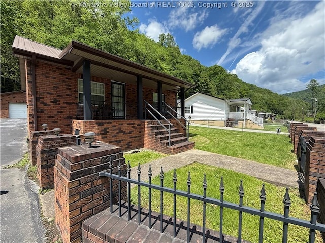 1886 Whitman Creek Rd, Whitman, WV 25652 - view of front of house with a porch, brick siding, a detached garage, and metal roof