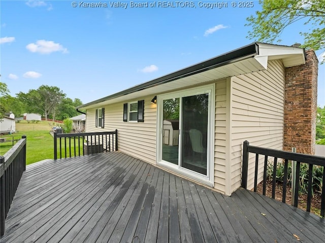 wooden terrace with a yard