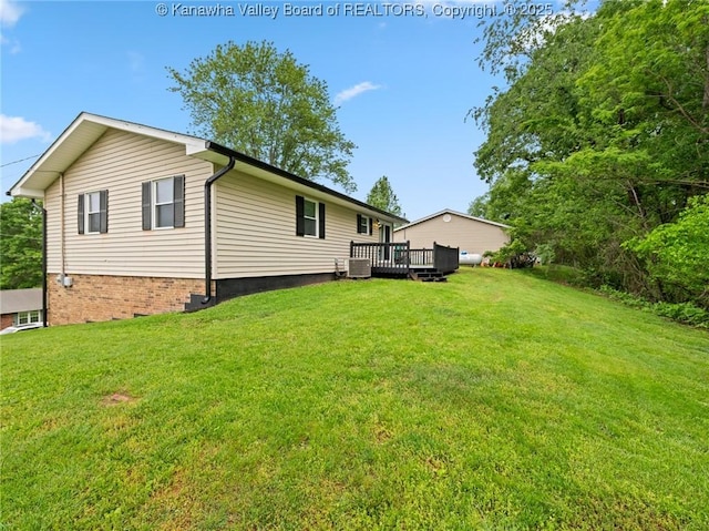 back of house featuring a wooden deck and a yard