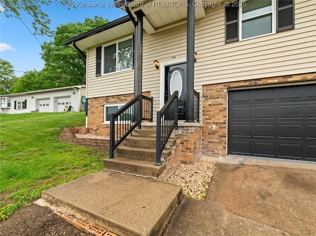 property entrance with brick siding, a lawn, and an attached garage