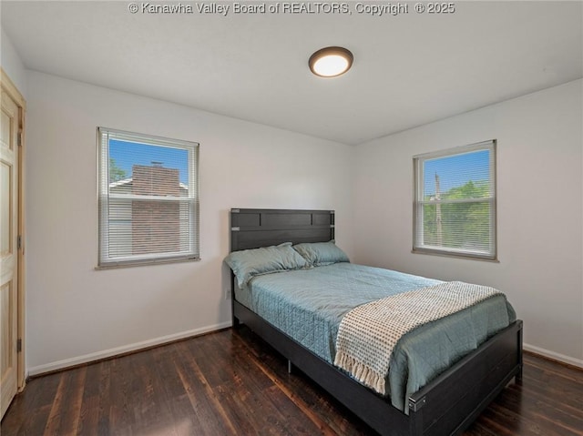 bedroom featuring baseboards and wood finished floors
