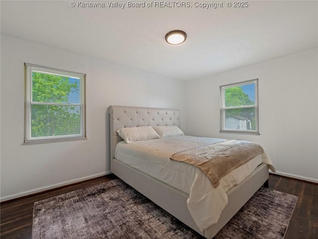 bedroom with wood finished floors and baseboards