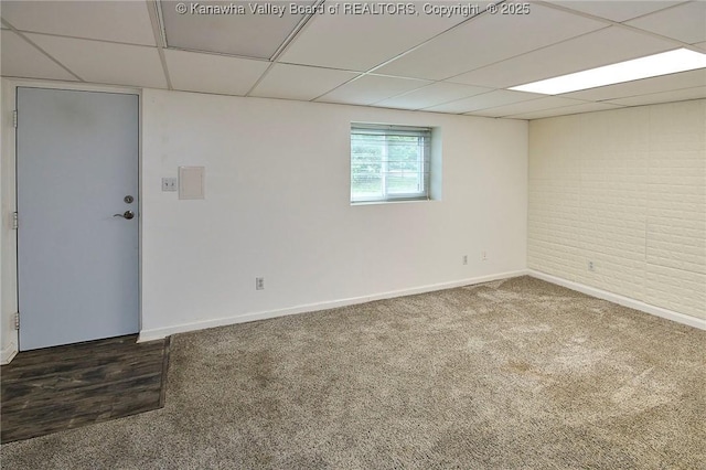 4707 A Marklana Ln, South Charleston, WV 25309 - unfurnished room featuring a paneled ceiling, baseboards, carpet floors, and brick wall