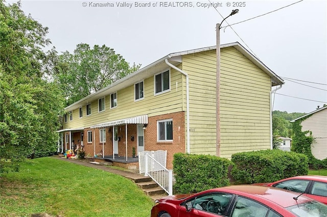 4707 A Marklana Ln, South Charleston, WV 25309 - back of house featuring a lawn and brick siding