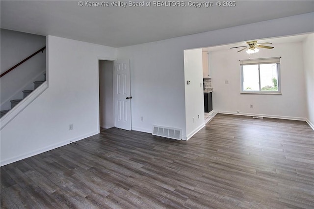 4707 A Marklana Ln, South Charleston, WV 25309 - unfurnished living room featuring stairway, a ceiling fan, dark wood-type flooring, and baseboards