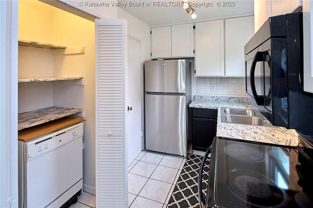 4707 A Marklana Ln, South Charleston, WV 25309 - kitchen featuring black appliances, white cabinetry, light tile patterned floors, and decorative backsplash