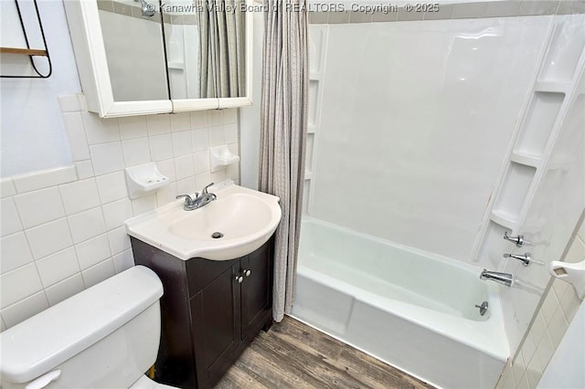 4707 A Marklana Ln, South Charleston, WV 25309 - bathroom with wood finished floors, vanity, shower / bath combination with curtain, tile walls, and toilet