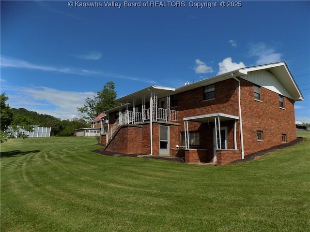 101 Ebony Dr, Cross Lanes, WV 25313 - rear view of house with brick siding and a lawn