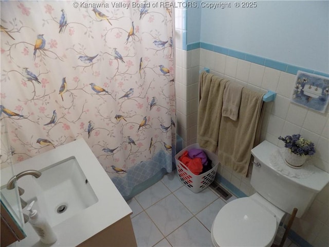 101 Ebony Dr, Cross Lanes, WV 25313 - full bath with tile walls, tile patterned floors, vanity, a shower with shower curtain, and toilet
