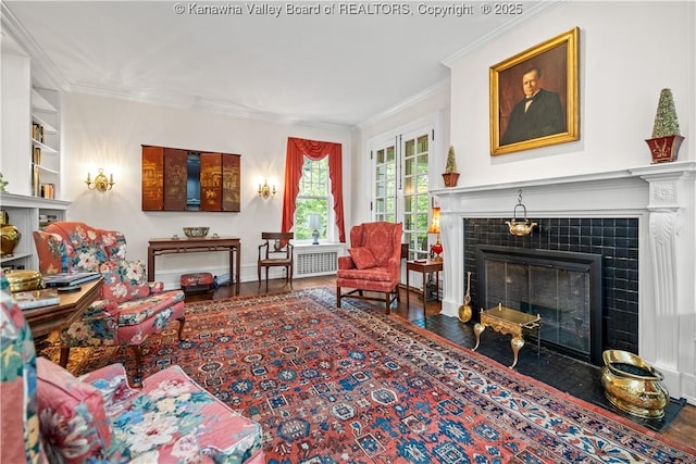 1223 Staunton Rd, Charleston, WV 25314 - living room with a tile fireplace, crown molding, wood finished floors, and radiator heating unit