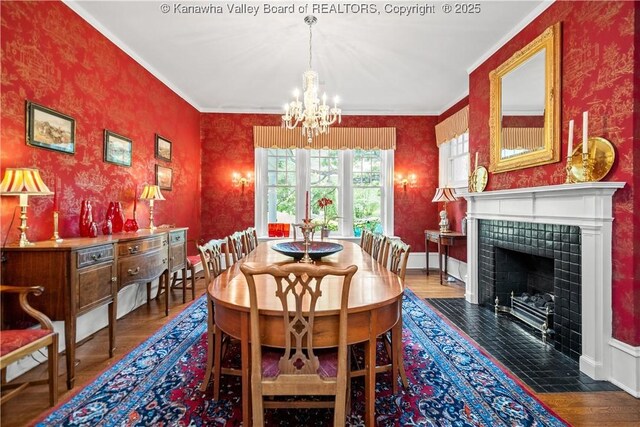 1223 Staunton Rd, Charleston, WV 25314 - dining room featuring wallpapered walls, a chandelier, wood finished floors, ornamental molding, and a tiled fireplace