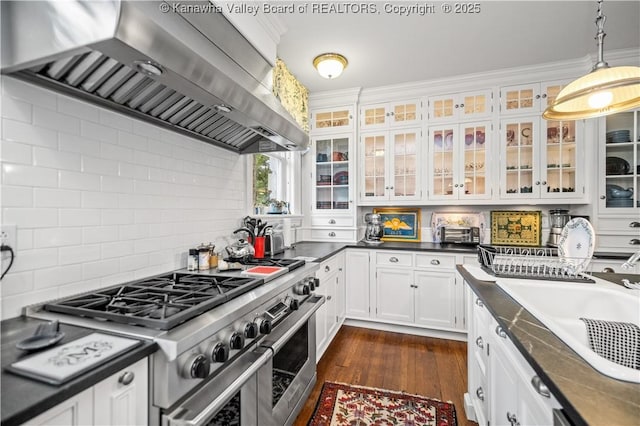1223 Staunton Rd, Charleston, WV 25314 - kitchen featuring wall chimney exhaust hood, double oven range, white cabinets, decorative backsplash, and dark wood-type flooring