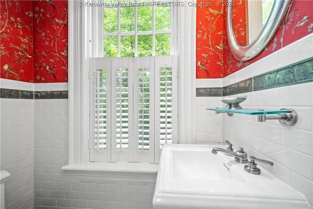1223 Staunton Rd, Charleston, WV 25314 - half bath featuring wallpapered walls, a sink, tile walls, and a wainscoted wall