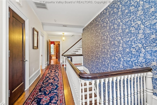 1223 Staunton Rd, Charleston, WV 25314 - corridor featuring wood finished floors, wallpapered walls, stairs, baseboards, and crown molding